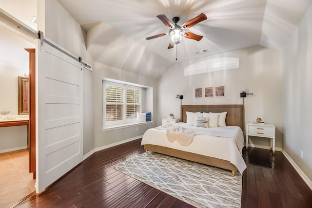 851 Carolina Way, Lantana, TX 76226 - bedroom featuring a barn door, vaulted ceiling, wood finished floors, baseboards, and ensuite bath
