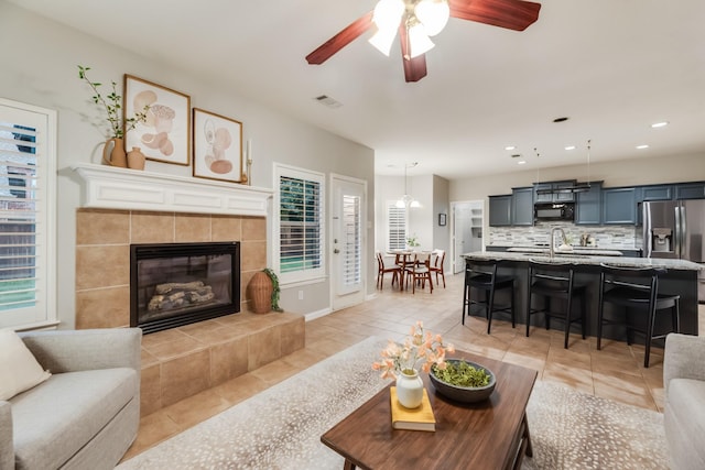 851 Carolina Way, Lantana, TX 76226 - living room featuring ceiling fan, recessed lighting, light tile patterned floors, a fireplace, and baseboards