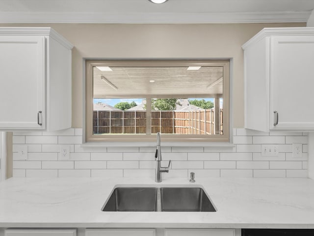 1308 River Birch Ln, Carrollton, TX 75007 - kitchen with a sink, white cabinetry, backsplash, and crown molding