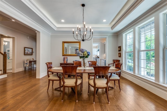 11240 Rosser Rd, Dallas, TX 75229 - dining space with wood finished floors, a chandelier, a tray ceiling, crown molding, and baseboards