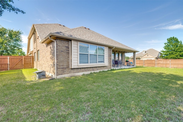 4806 Ashbury Ln, Mansfield, TX 76063 - back of property with a patio area, brick siding, and a shingled roof
