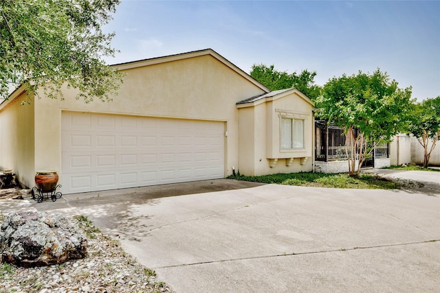 4009 Scenic Way, Granbury, TX 76049 - view of front of home with concrete driveway, stucco siding, and an attached garage