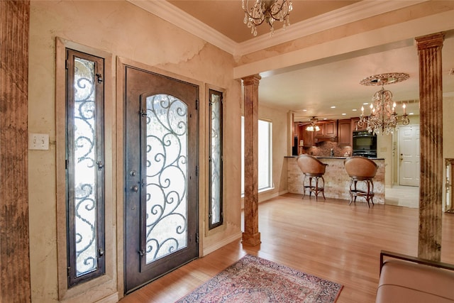 4009 Scenic Way, Granbury, TX 76049 - entryway featuring ornate columns, a chandelier, ornamental molding, and light wood-type flooring