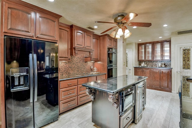 4009 Scenic Way, Granbury, TX 76049 - kitchen with black appliances, ceiling fan, decorative backsplash, dark stone countertops, and beverage cooler