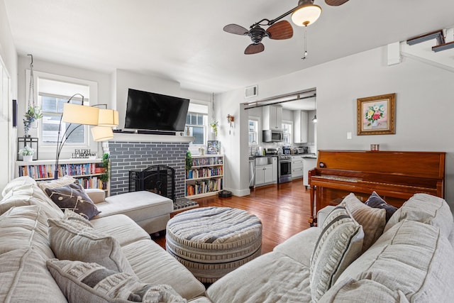 2236 Alston Ave, Fort Worth, TX 76110 - living area with ceiling fan, wood finished floors, and a fireplace