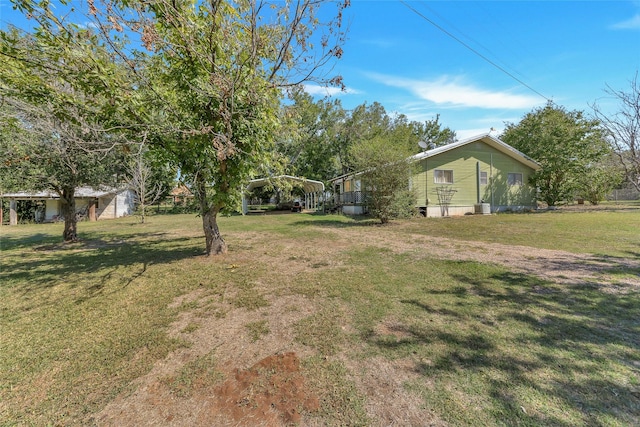 723 Leftys Ct, Possum Kingdom Lake, TX 76449 - view of green lawn featuring a carport and central AC