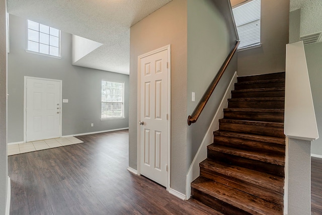 1010 Hanover Dr, Forney, TX 75126 - staircase with wood finished floors, baseboards, and a textured ceiling
