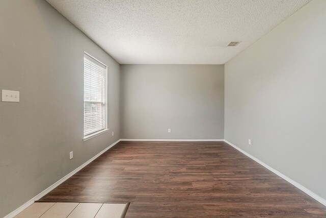 1010 Hanover Dr, Forney, TX 75126 - spare room with a textured ceiling, wood finished floors, and baseboards