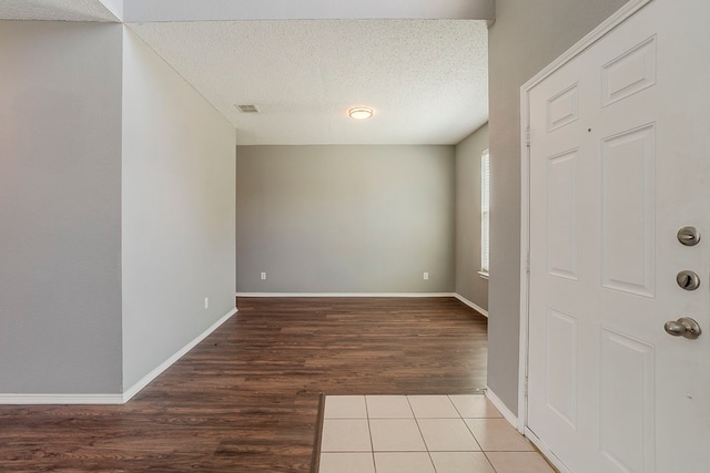 1010 Hanover Dr, Forney, TX 75126 - spare room with wood finished floors, a textured ceiling, and baseboards