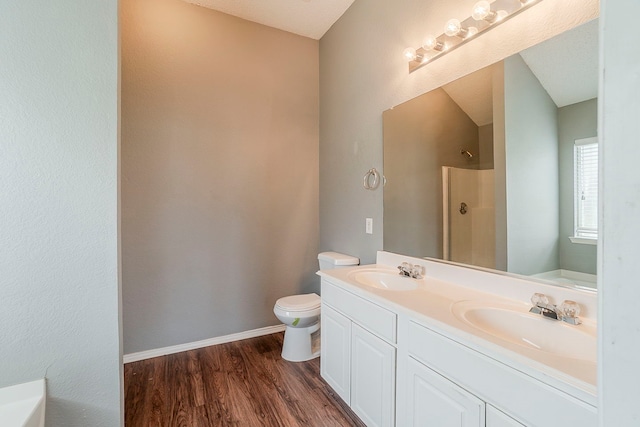 1010 Hanover Dr, Forney, TX 75126 - bathroom featuring a shower, toilet, wood finished floors, double vanity, and a bathtub
