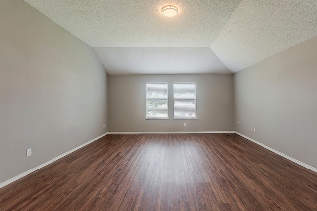 1010 Hanover Dr, Forney, TX 75126 - bonus room with dark wood-style flooring, baseboards, a textured ceiling, and vaulted ceiling