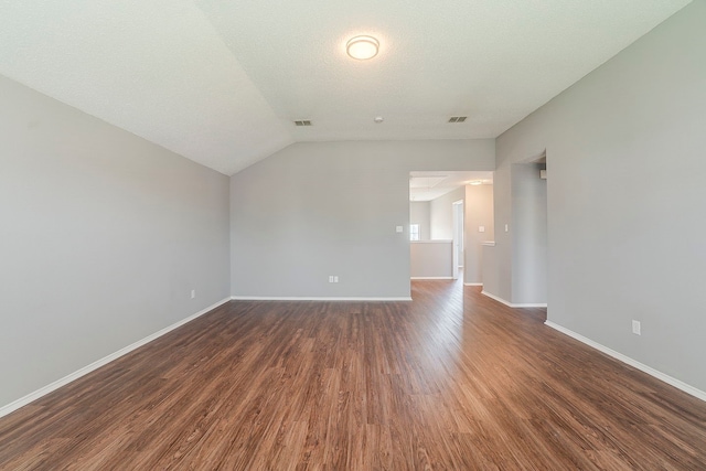 1010 Hanover Dr, Forney, TX 75126 - unfurnished living room with baseboards, dark wood-type flooring, and vaulted ceiling