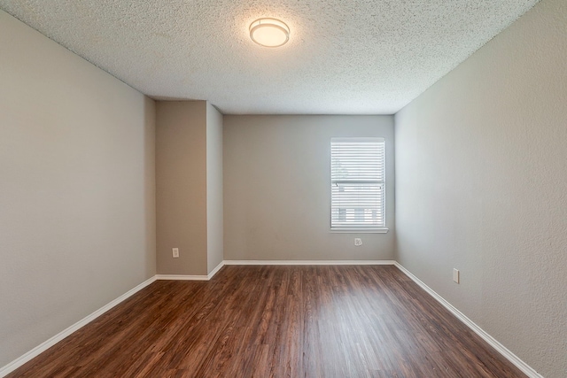 1010 Hanover Dr, Forney, TX 75126 - spare room with dark wood-style flooring, baseboards, and a textured ceiling