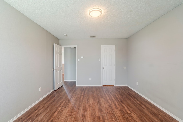 1010 Hanover Dr, Forney, TX 75126 - unfurnished bedroom with wood finished floors, a textured ceiling, and baseboards