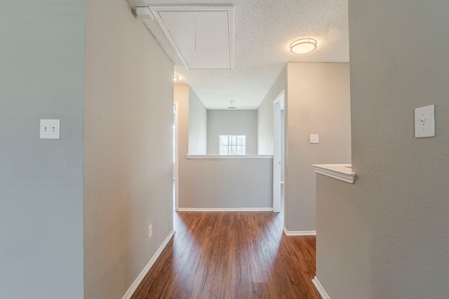 1010 Hanover Dr, Forney, TX 75126 - hallway featuring attic access, wood finished floors, baseboards, and a textured ceiling