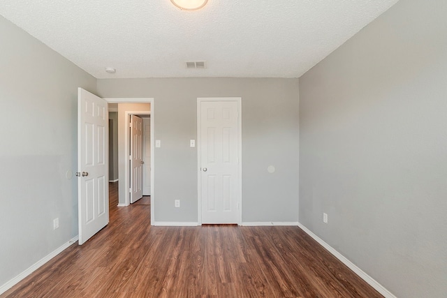 1010 Hanover Dr, Forney, TX 75126 - unfurnished bedroom featuring wood finished floors, baseboards, and a textured ceiling