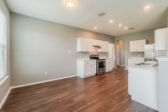 1010 Hanover Dr, Forney, TX 75126 - kitchen with stainless steel appliances, a sink, arched walkways, dark wood-style floors, and baseboards