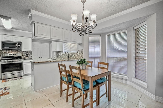 7333 Mesa Verde Trl, Fort Worth, TX 76137 - dining area with light tile patterned flooring, a textured ceiling, a chandelier, ornamental molding, and baseboards