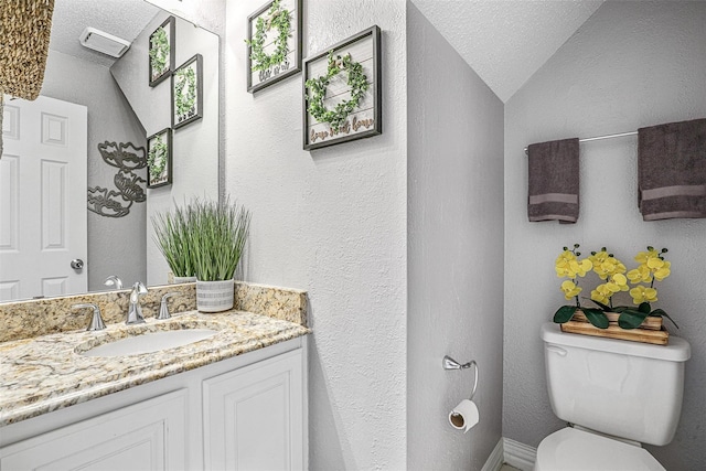 7333 Mesa Verde Trl, Fort Worth, TX 76137 - half bath with toilet, vanity, lofted ceiling, a textured ceiling, and a textured wall