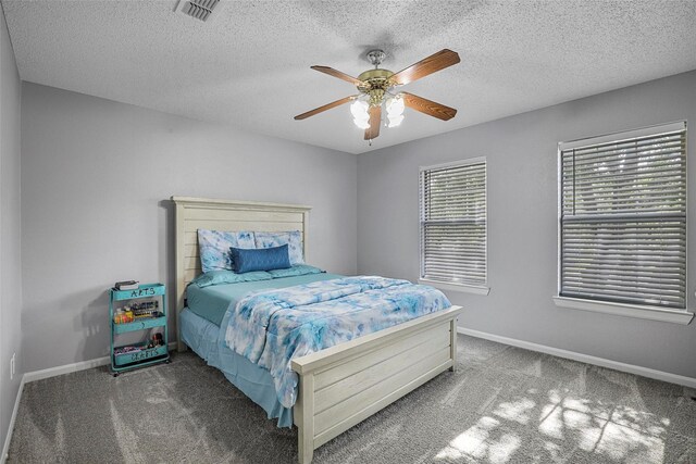 7333 Mesa Verde Trl, Fort Worth, TX 76137 - bedroom with carpet, baseboards, a ceiling fan, and a textured ceiling