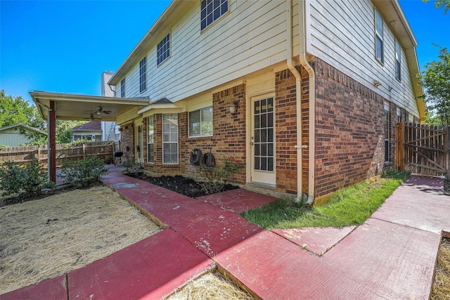 7333 Mesa Verde Trl, Fort Worth, TX 76137 - view of side of home featuring a ceiling fan, brick siding, and a patio