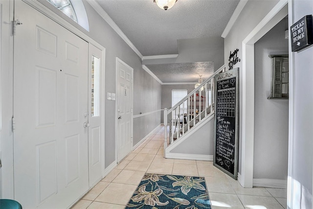 7333 Mesa Verde Trl, Fort Worth, TX 76137 - tiled foyer featuring a textured ceiling, stairs, crown molding, and baseboards