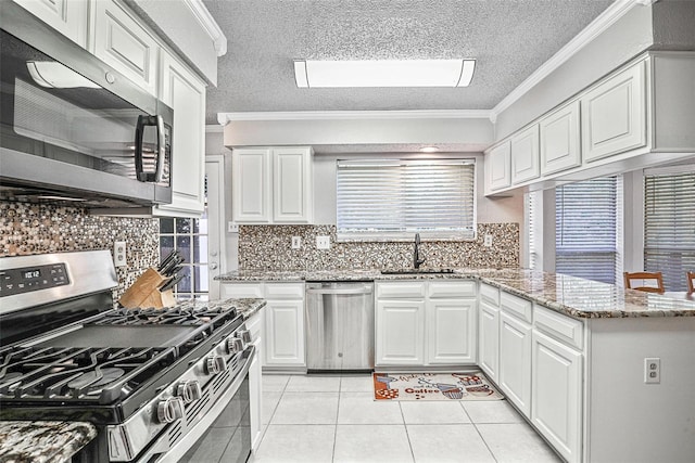 7333 Mesa Verde Trl, Fort Worth, TX 76137 - kitchen featuring appliances with stainless steel finishes, a sink, ornamental molding, white cabinets, and light tile patterned flooring