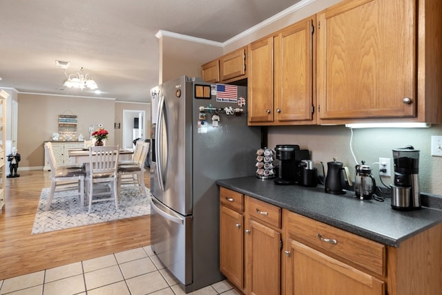 107 Camino Robles St, Gun Barrel City, TX 75156 - kitchen featuring stainless steel refrigerator with ice dispenser, crown molding, dark countertops, light tile patterned floors, and a chandelier