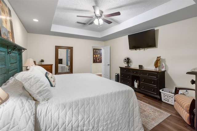 203 Marianne, Sulphur Springs, TX 75482 - bedroom featuring a tray ceiling, wood finished floors, ceiling fan, a textured ceiling, and recessed lighting