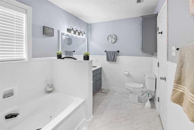 203 Marianne, Sulphur Springs, TX 75482 - bathroom with a textured ceiling, marble finish flooring, a bath, vanity, and toilet