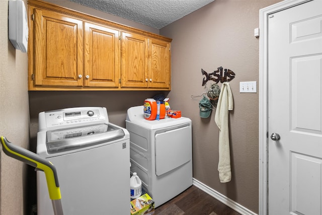 203 Marianne, Sulphur Springs, TX 75482 - washroom featuring washing machine and dryer, cabinet space, dark wood-style floors, baseboards, and a textured ceiling