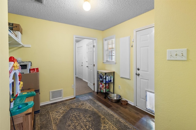 203 Marianne, Sulphur Springs, TX 75482 - foyer entrance featuring a textured ceiling, wood finished floors, and baseboards