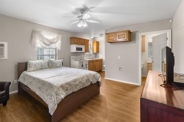 203 Marianne, Sulphur Springs, TX 75482 - bedroom featuring wood finished floors, baseboards, a sink, ensuite bathroom, and a ceiling fan