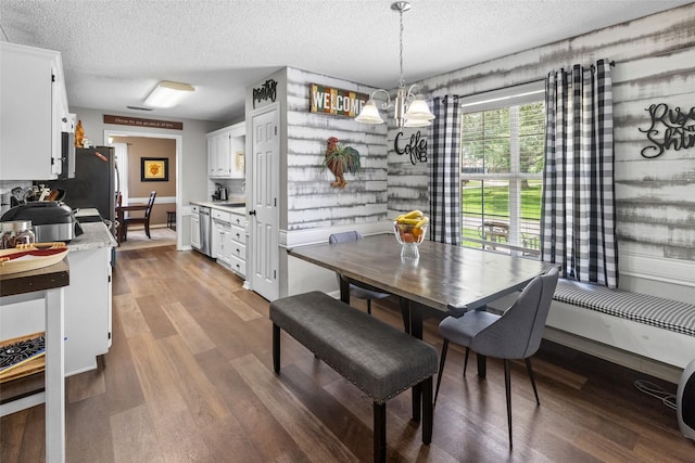 203 Marianne, Sulphur Springs, TX 75482 - dining room with a textured ceiling, wood finished floors, a chandelier, and baseboards