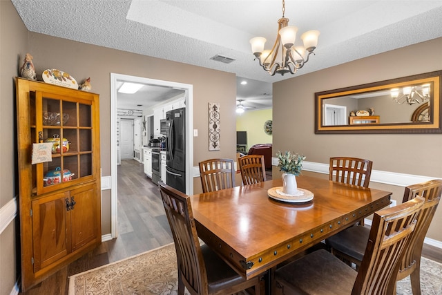 203 Marianne, Sulphur Springs, TX 75482 - dining space featuring a chandelier, dark wood finished floors, and baseboards