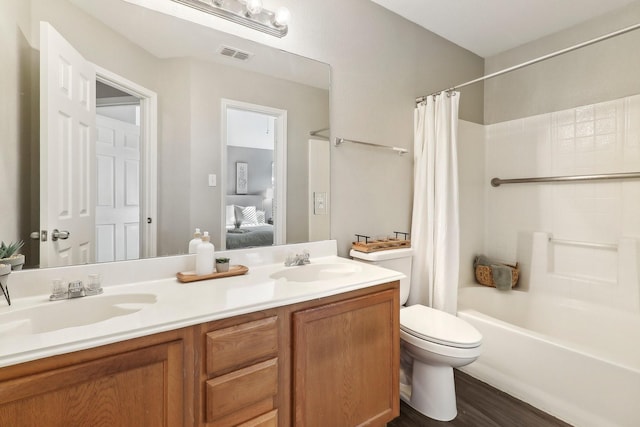 7243 Irish Valley Trl, Fort Worth, TX 76123 - ensuite bathroom with double vanity, shower / tub combo, toilet, and wood finished floors