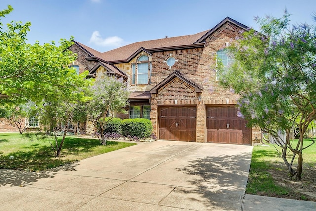 5040 Pallas Ct, Fort Worth, TX 76123 - view of front of home featuring brick siding, a garage, driveway, roof with shingles, and a front lawn