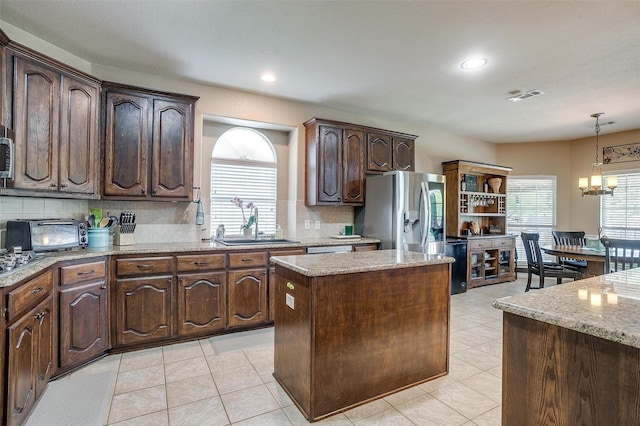 5040 Pallas Ct, Fort Worth, TX 76123 - kitchen featuring a sink, a kitchen island, plenty of natural light, dark brown cabinets, and recessed lighting