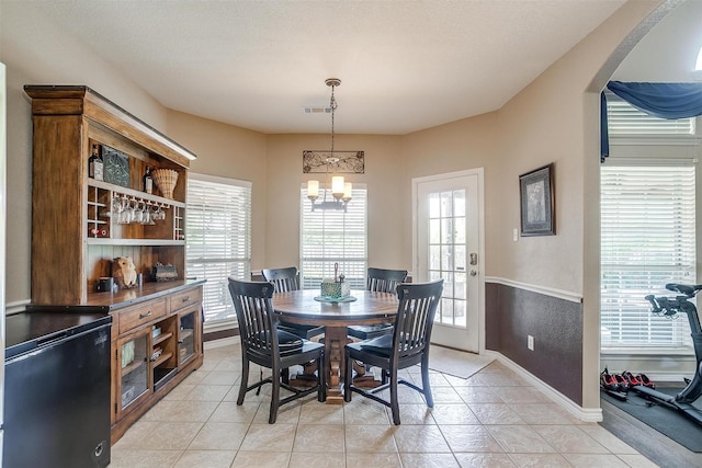 5040 Pallas Ct, Fort Worth, TX 76123 - dining space featuring healthy amount of natural light, baseboards, arched walkways, and a chandelier