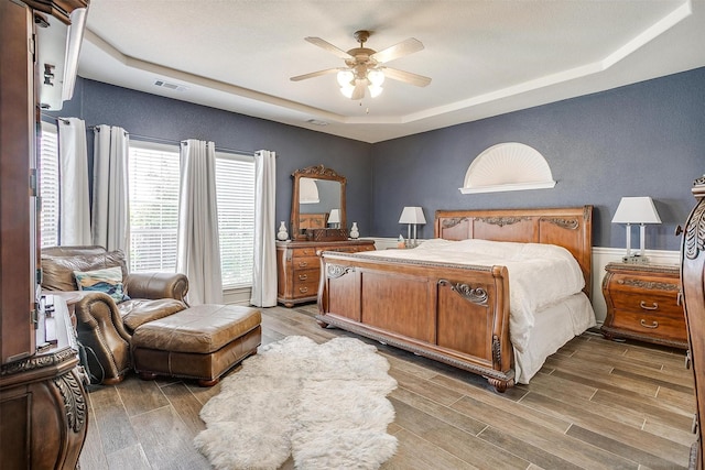 5040 Pallas Ct, Fort Worth, TX 76123 - bedroom featuring a raised ceiling, wood finished floors, and a ceiling fan