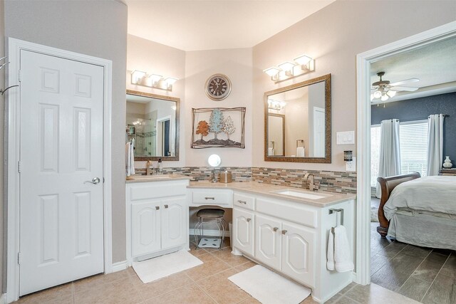 5040 Pallas Ct, Fort Worth, TX 76123 - bathroom featuring double vanity, connected bathroom, backsplash, ceiling fan, and tile patterned floors