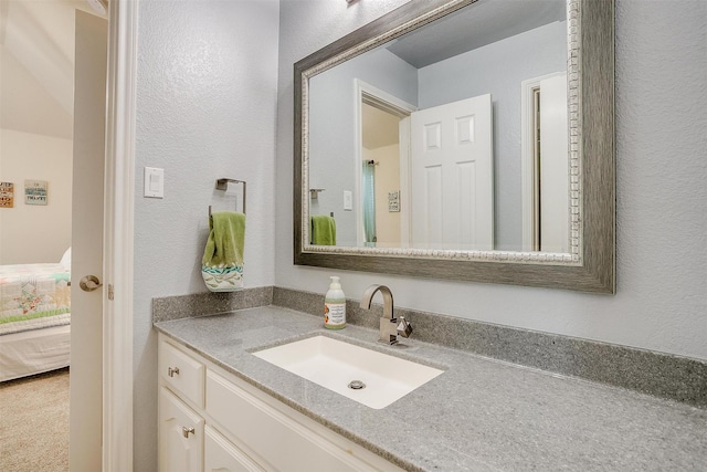 5040 Pallas Ct, Fort Worth, TX 76123 - bathroom with vanity, a textured wall, and ensuite bathroom