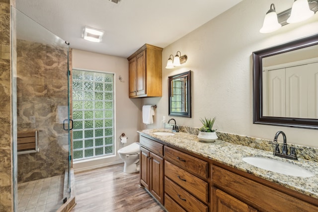 142 Peninsula Point Ter, Mabank, TX 75156 - full bathroom with toilet, double vanity, wood finished floors, and a shower stall