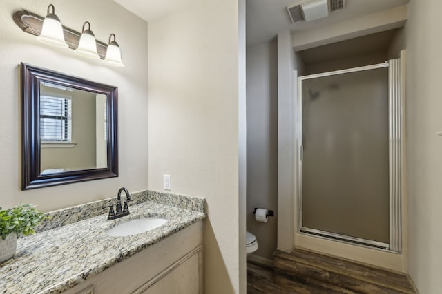 142 Peninsula Point Ter, Mabank, TX 75156 - full bathroom with wood finished floors, a stall shower, vanity, and toilet