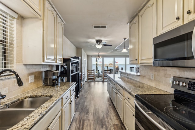 142 Peninsula Point Ter, Mabank, TX 75156 - kitchen featuring cream cabinets and appliances with stainless steel finishes