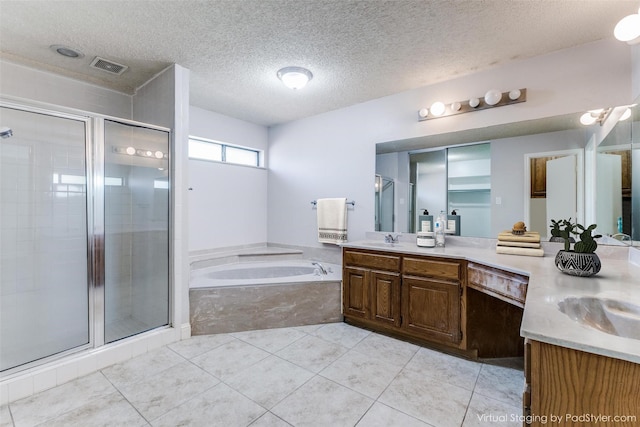 18609 Crownover Ct, Dallas, TX 75252 - bathroom with vanity, a stall shower, a garden tub, a textured ceiling, and tile patterned flooring