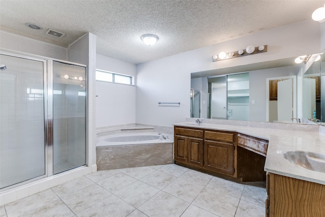 18609 Crownover Ct, Dallas, TX 75252 - bathroom with double vanity, a garden tub, a stall shower, a textured ceiling, and tile patterned flooring