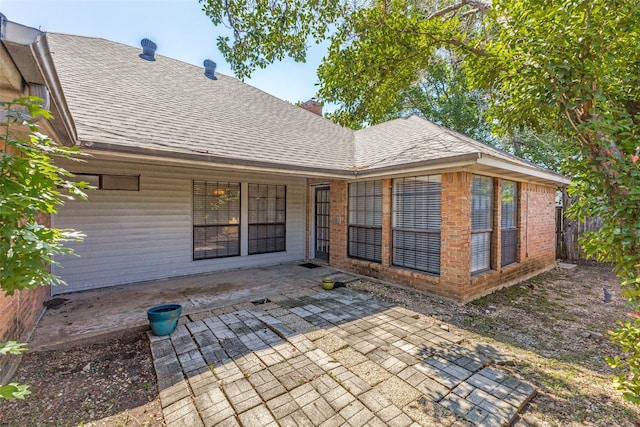 18609 Crownover Ct, Dallas, TX 75252 - rear view of property with a patio, roof with shingles, a chimney, and brick siding
