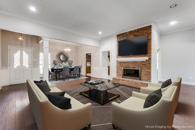 18609 Crownover Ct, Dallas, TX 75252 - living room featuring wood finished floors, decorative columns, crown molding, a decorative wall, and wainscoting