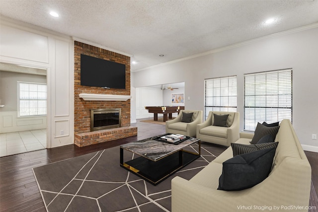 18609 Crownover Ct, Dallas, TX 75252 - living room featuring a textured ceiling, wood finished floors, a decorative wall, crown molding, and a wainscoted wall